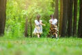 Happy children playing on the green grass in the spring garden. Two little sisters are running on a meadow in a summer park Royalty Free Stock Photo