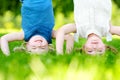 Happy children playing head over heels on green grass Royalty Free Stock Photo