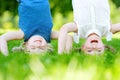 Happy children playing head over heels on green grass Royalty Free Stock Photo