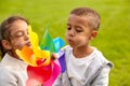 happy children playing with pinwheel at park Royalty Free Stock Photo