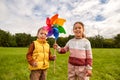 happy children playing with pinwheel at park Royalty Free Stock Photo