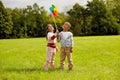 happy children playing with pinwheel at park Royalty Free Stock Photo