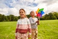 happy children playing with pinwheel at park Royalty Free Stock Photo