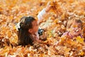 Happy children playing, posing, smiling and having fun in autumn city park. Bright yellow trees and leaves Royalty Free Stock Photo
