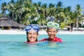 Happy children playing in the sea. Kids having fun outdoors. Summer vacation and healthy lifestyle concept Royalty Free Stock Photo