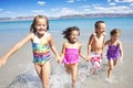 Happy Children playing and Splashing in the Ocean