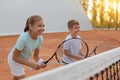 Happy children playing tennis on court outdoors Royalty Free Stock Photo