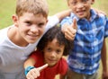 Happy children, portrait and thumbs up in nature for teamwork, winning or good job together at park. Group of casual Royalty Free Stock Photo