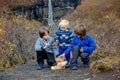 Happy children, posing in front of beautiful waterfall Svartifoss in Skaftafell national park i Royalty Free Stock Photo