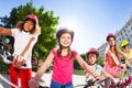 Happy children riding bikes in summer city Royalty Free Stock Photo