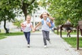 Happy children run from school with backpacks. The concept of school, study, education, friendship, childhood.