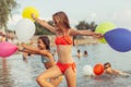 Happy children running with balloons through the water Royalty Free Stock Photo