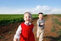 Happy children running in the meadow Royalty Free Stock Photo