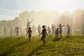 Happy children running through the spray of water