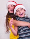 Happy children with Santa Claus red hats Royalty Free Stock Photo