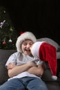 Happy children in Santa hat at home on Christmas Eve. Waiting for the new year. Vertical frame Royalty Free Stock Photo