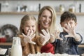 Children showing dirty hands after baking