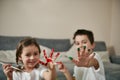 Happy children showing their hands smeared with colored paints to the camera Royalty Free Stock Photo