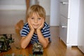 Happy children, siblings, boy, playing with tanks and soldiers at home Royalty Free Stock Photo