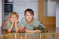 Happy children, siblings, boy, playing with tanks and soldiers at home Royalty Free Stock Photo