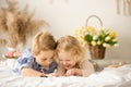 Happy children, siblings, enjoying Easter holiday together, tradition with handmade twig, braided whip made from pussy willow