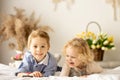 Happy children, siblings, enjoying Easter holiday together, tradition with handmade twig, braided whip made from pussy willow