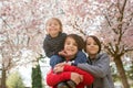 Happy children, siblings in pink blooming sacura garden, playing