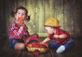 Happy children sister and baby brother with a basket of peaches Royalty Free Stock Photo