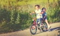 Happy children sister girl cyclist riding a bike