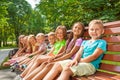 Happy children sit on the bench in park Royalty Free Stock Photo