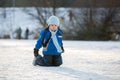 Happy children, skating on a frozen lake in the park