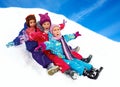 Happy children sledding at winter time Royalty Free Stock Photo