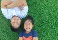 Happy children smile and lie down on grass Royalty Free Stock Photo