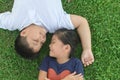 Happy children smile and lie down on grass Royalty Free Stock Photo