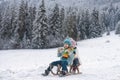 Happy children in snow. Two kids ride on a wooden retro sled on a winter day. Active winter outdoors games. Happy Royalty Free Stock Photo
