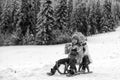 Happy children in snow. Two kids ride on a wooden retro sled on a winter day. Active winter outdoors games. Happy Royalty Free Stock Photo