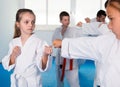 Happy children sparring in pairs in karate class Royalty Free Stock Photo
