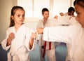 Happy children sparring in pairs in karate class Royalty Free Stock Photo