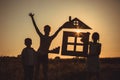 Happy children standing on the field at the sunset time Royalty Free Stock Photo
