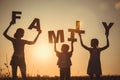 Happy children standing on the field at the sunset time Royalty Free Stock Photo