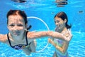 Happy children swim in pool underwater, girls swimming Royalty Free Stock Photo