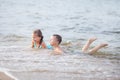 Happy children swimming in the sea, waves and splashes from swimming in the sea Royalty Free Stock Photo