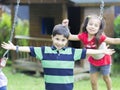 Happy children swinging Royalty Free Stock Photo