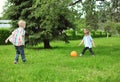 Happy children two boys together playing football with ball Royalty Free Stock Photo