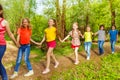 Happy children walking in the forest holding hands Royalty Free Stock Photo