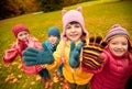 Happy children waving hands in autumn park Royalty Free Stock Photo