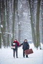 Happy children in a winter park, playing together with a sledge Royalty Free Stock Photo