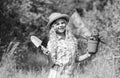 Happy childrens day. Happy childhood. Child in hat with shoulder blade small shovel hoe. Happy smiling gardener girl Royalty Free Stock Photo