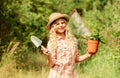 Happy childrens day. Happy childhood. Child in hat with shoulder blade small shovel hoe. Happy smiling gardener girl Royalty Free Stock Photo