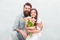 Happy childrens day. Happy family celebrate childrens day. Father embrace little daughter holding flowers. Bearded man